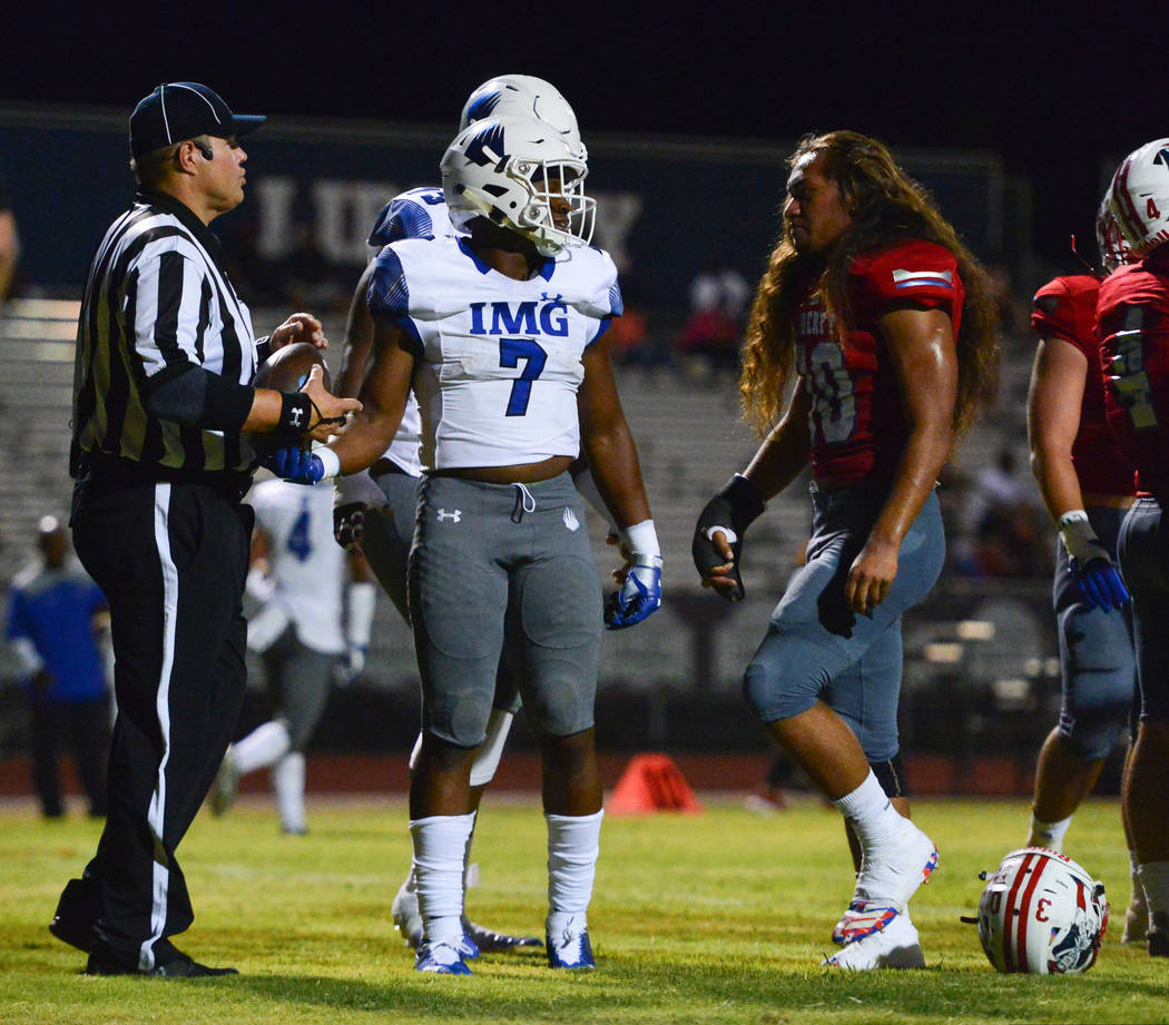 Liberty's Zyrus Fiaseu (30) stares down IMG Academy's running back Noah Cain (7) after Cain scored a touchdown at Liberty High School in Henderson on Friday, Sept. 7, 2018. IMG Academy leads at ha ...