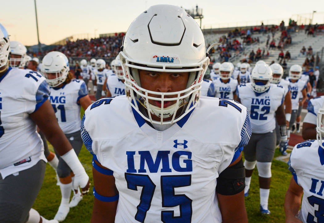 IMG Academy offensive lineman Charles Turner (75) leads his team onto the field before a game against Liberty High School at Liberty High School in Henderson on Friday, Sept. 7, 2018. IMG Academy ...