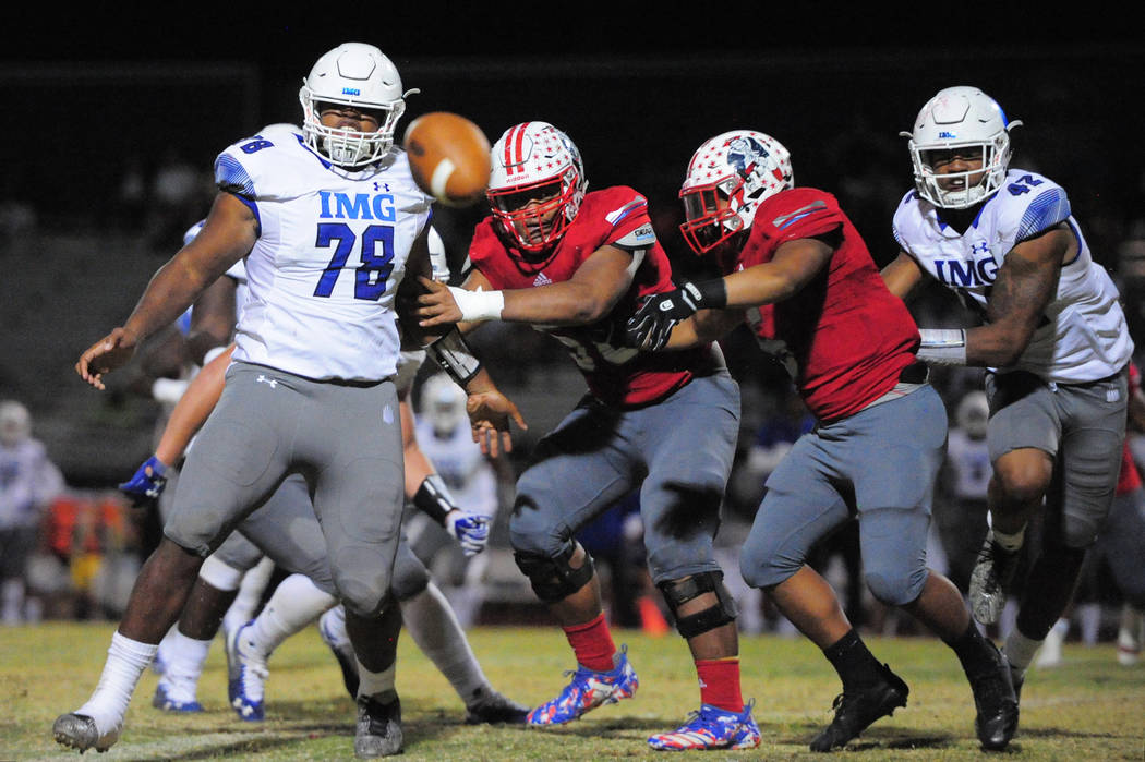 IMG Academy's Antoine Whitner Jr. (78), Liberty's A.J. Maluia (58), Ezra Thomhoon (5) and IMG Academy's Nolan Smith (42) watch a Liberty fumble that was returned for an IMG touchdown at Liberty H ...