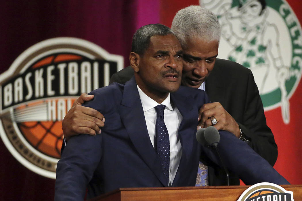 Maurice Cheeks, left, is hugged by Hall of Famer Julius Erving while speaking during induction ceremonies into the Basketball Hall of Fame, Friday, Sept. 7, 2018, in Springfield, Mass. (AP Photo/E ...