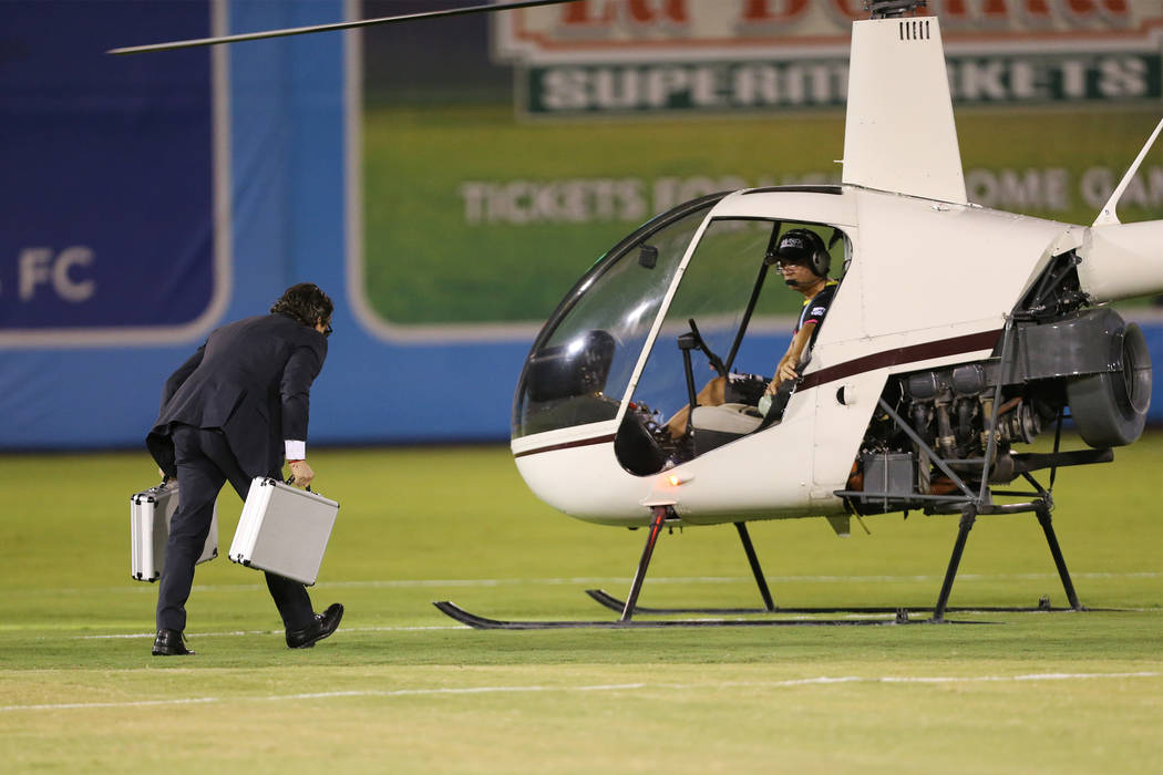 A person transfers $5,000 to helicopter for a half time cash drop during an USL soccer game between the Las Vegas Lights and LA galaxy II at Cashman Field in Las Vegas, Saturday, Sept. 8, 2018. Er ...