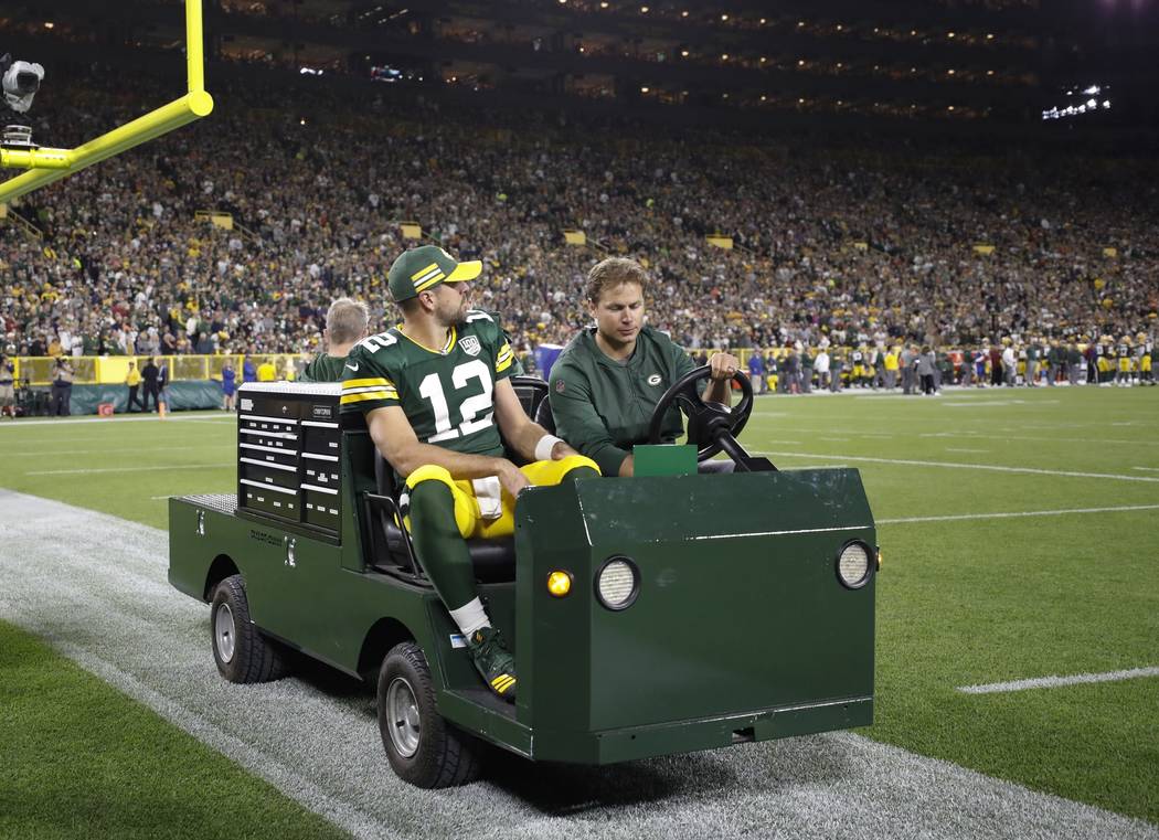 Green Bay Packers' Aaron Rodgers is taken off the field on a cart after injuring his leg during the first half of an NFL football game against the Chicago Bears Sunday, Sept. 9, 2018, in Green Bay ...