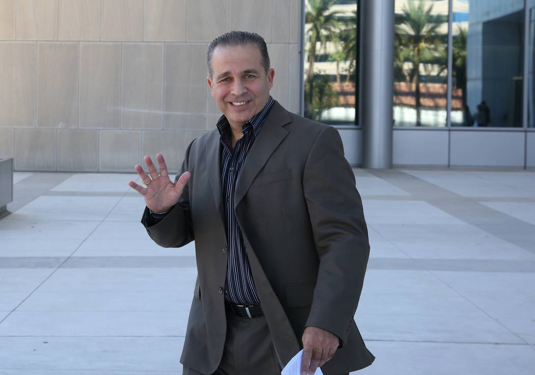 Peter Santilli Jr., a defendant charged in the case involving the armed standoff in Bunkerville, waves as he leaves the Lloyd George U.S. Courthouse on Tuesday, Sept. 11, 2018, in Las Vegas. (Bizu ...