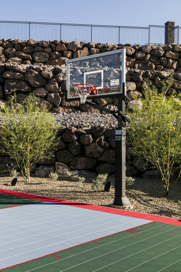 A half-size basketball court is outside. (Sun West Custom Homes)