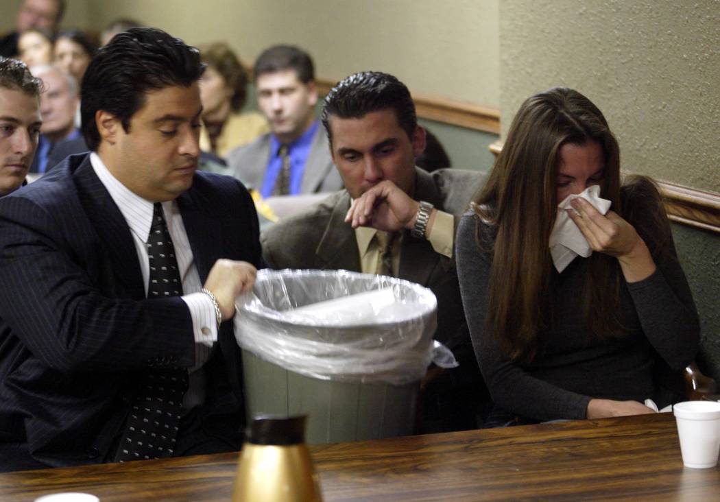 Attorney Michael Cristalli grabs a garbage can in November 2004 while a nervous Sandy Murphy gets sick before the verdicts were read at her second murder trial. Murphy was found not guilty. (File ...