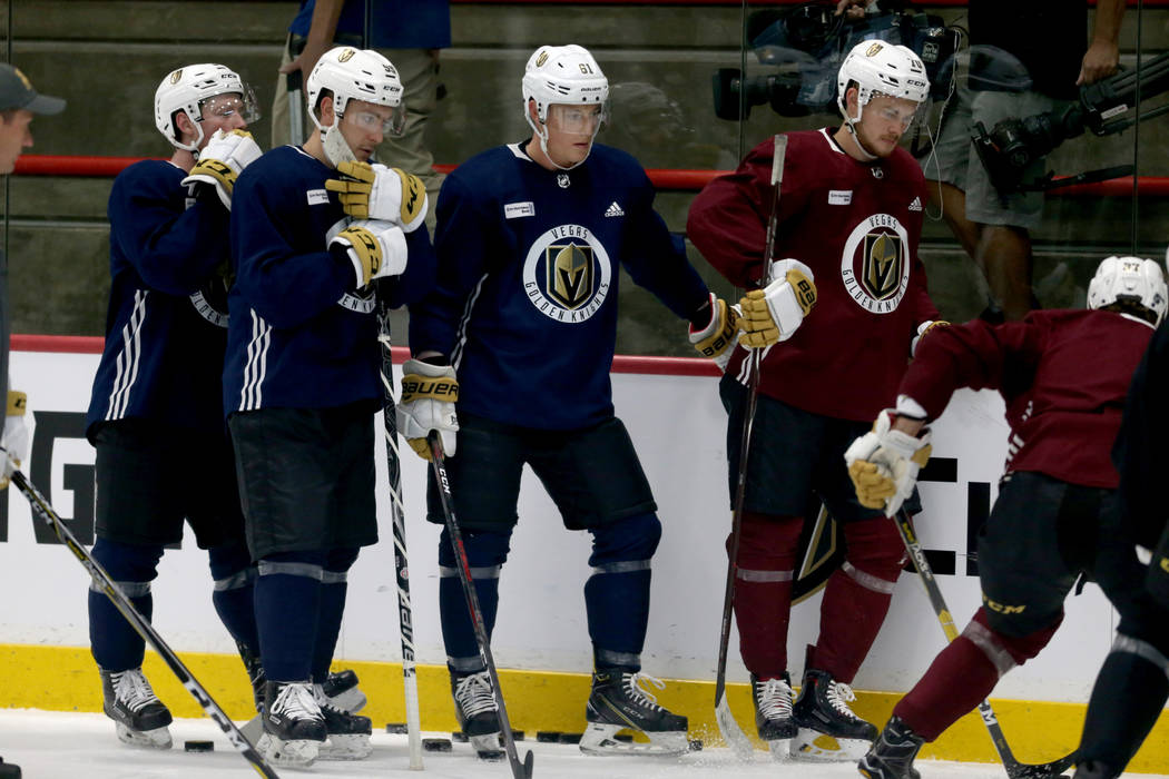 The Vegas Golden Knights Pierre-Edouard Bellemare, left, Brad Hunt