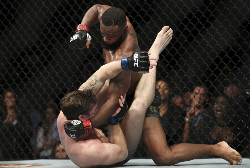 Tyron Woodley, top, pummels a fallen Darren Till during their welterweight title mixed martial arts bout at UFC 228 on Saturday, Sept. 8, 2018, in Dallas. (AP Photo/Jeffrey McWhorter)
