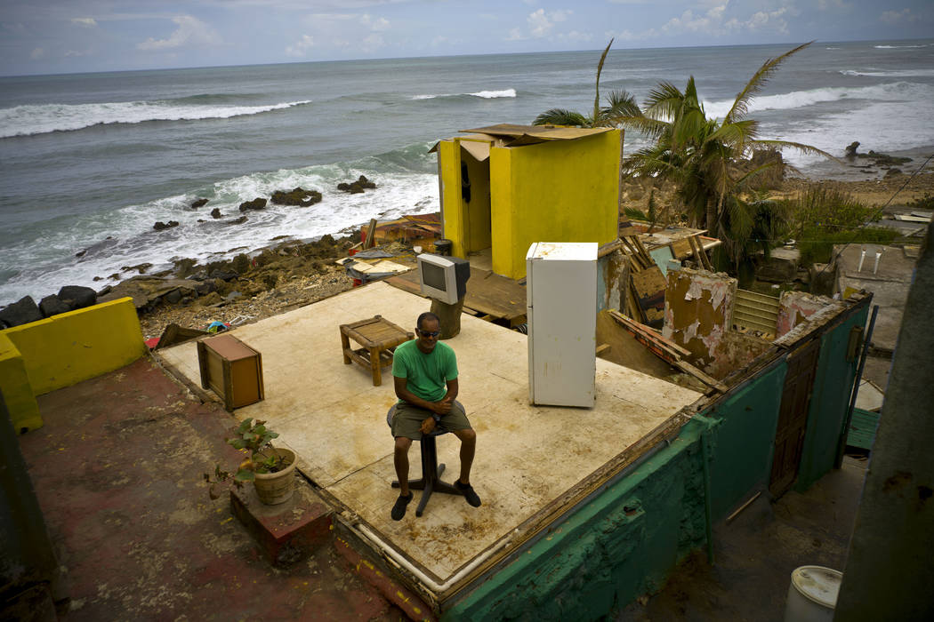 Roberto Figueroa Caballero sits in his home destroyed by Hurricane Maria, two weeks after the storm hit La Perla neighborhood on the coast of San Juan, Puerto Rico, Oct. 5, 2017. Figueroa, who wan ...