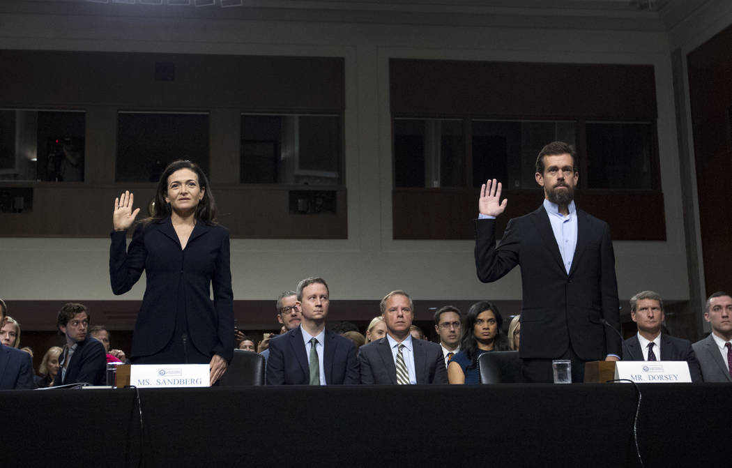 Facebook COO Sheryl Sandberg, left, accompanied by Twitter CEO Jack Dorsey are sworn in before the Senate Intelligence Committee hearing on 'Foreign Influence Operations and Their Use of Social Me ...