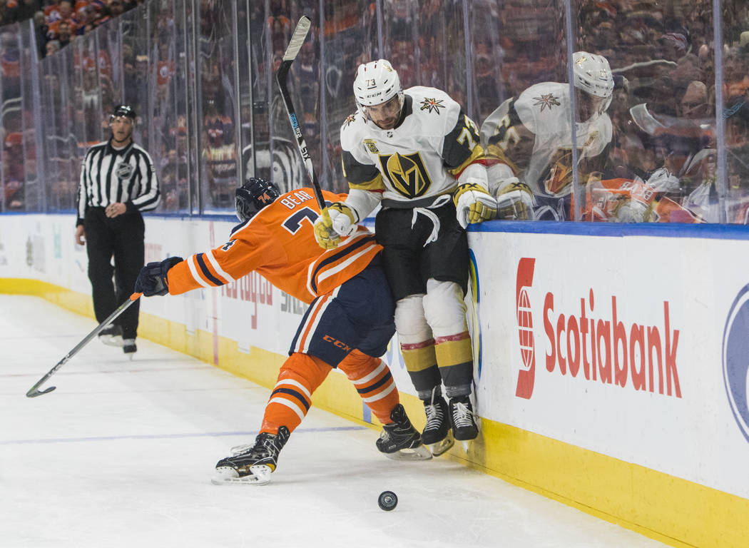 Vegas Golden Knights' Brandon Pirri (73) is checked by Edmonton Oilers' Ethan Bear (74) during first-period NHL hockey game action in Edmonton, Alberta, Thursday, April 5, 2018. (Amber Bracken/The ...