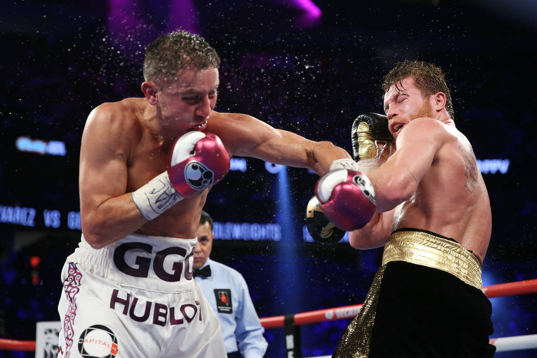Gennady Golovkin, left, connects a punch against Saul "Canelo" Alvarez in the WBC, WBA, IBO, RING middleweight title bout at T-Mobile Arena in Las Vegas, Saturday, Sept. 15, 2018. Alvare ...