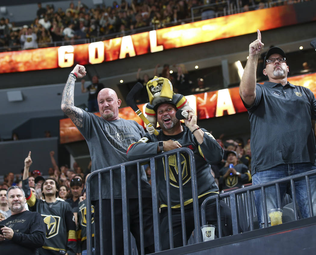 Golden Knights fans celebrate a goal by Golden Knights center Jonathan Marchessault, not pictured, during the first period of a preseason NHL hockey game against the Arizona Coyotes at T-Mobile Ar ...