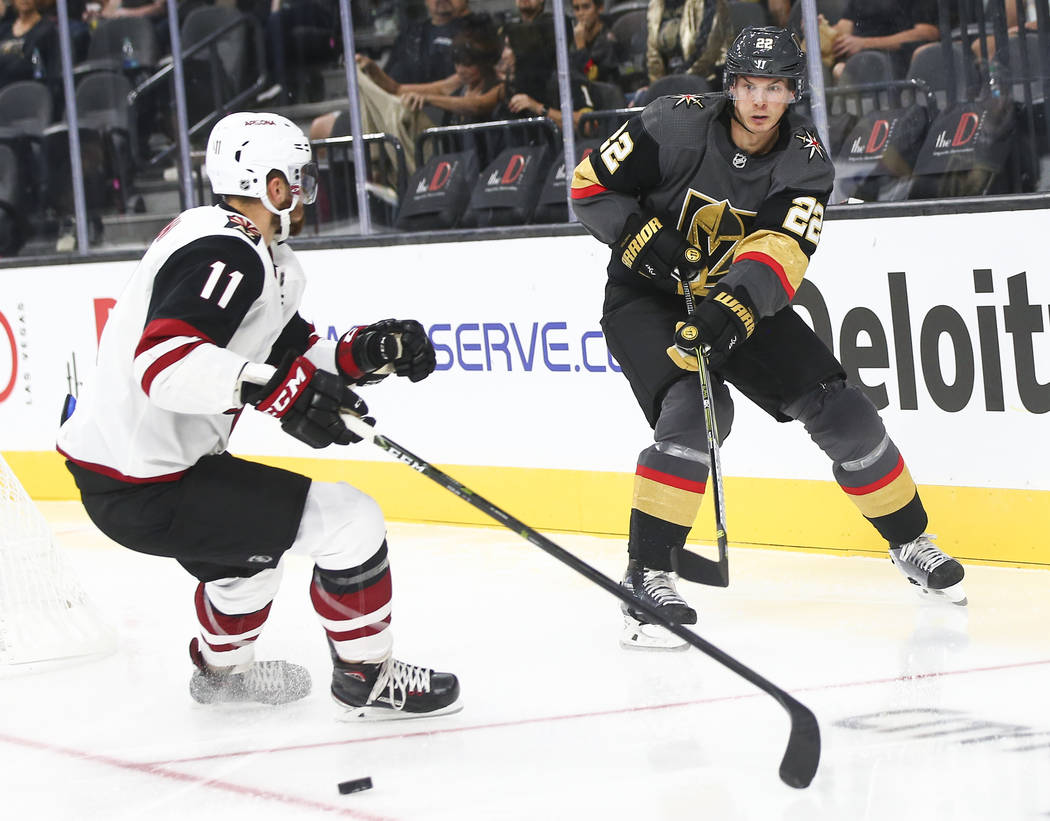 Golden Knights defenseman Nick Holden (22) sends the puck past Arizona Coyotes left wing Brendan Perlini (11) during the second period of a preseason NHL hockey game at T-Mobile Arena in Las Vegas ...