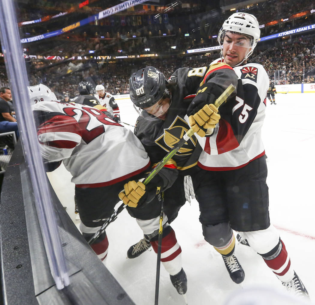Golden Knights Tyler Wong (80) battles Arizona Coyotes Kyle Capobianco (75) during the first period of a preseason NHL hockey game at T-Mobile Arena in Las Vegas on Sunday, Sept. 16, 2018. Chase S ...