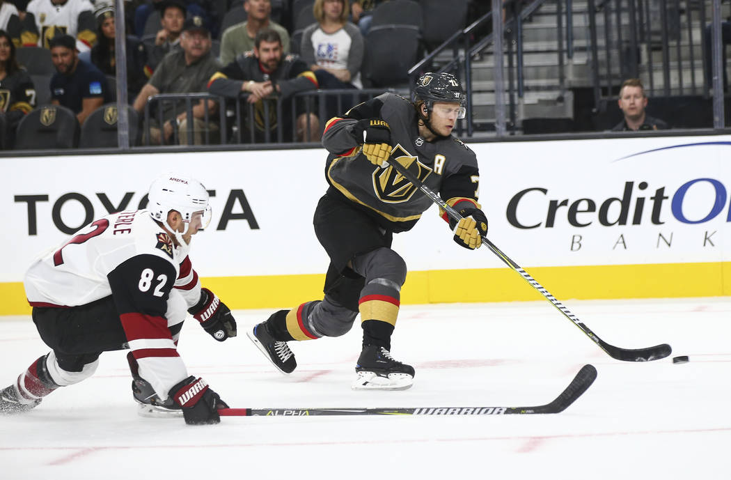 Golden Knights center William Karlsson (71) shoots past Arizona Coyotes Hudson Wilson (82) during the first period of a preseason NHL hockey game at T-Mobile Arena in Las Vegas on Sunday, Sept. 16 ...