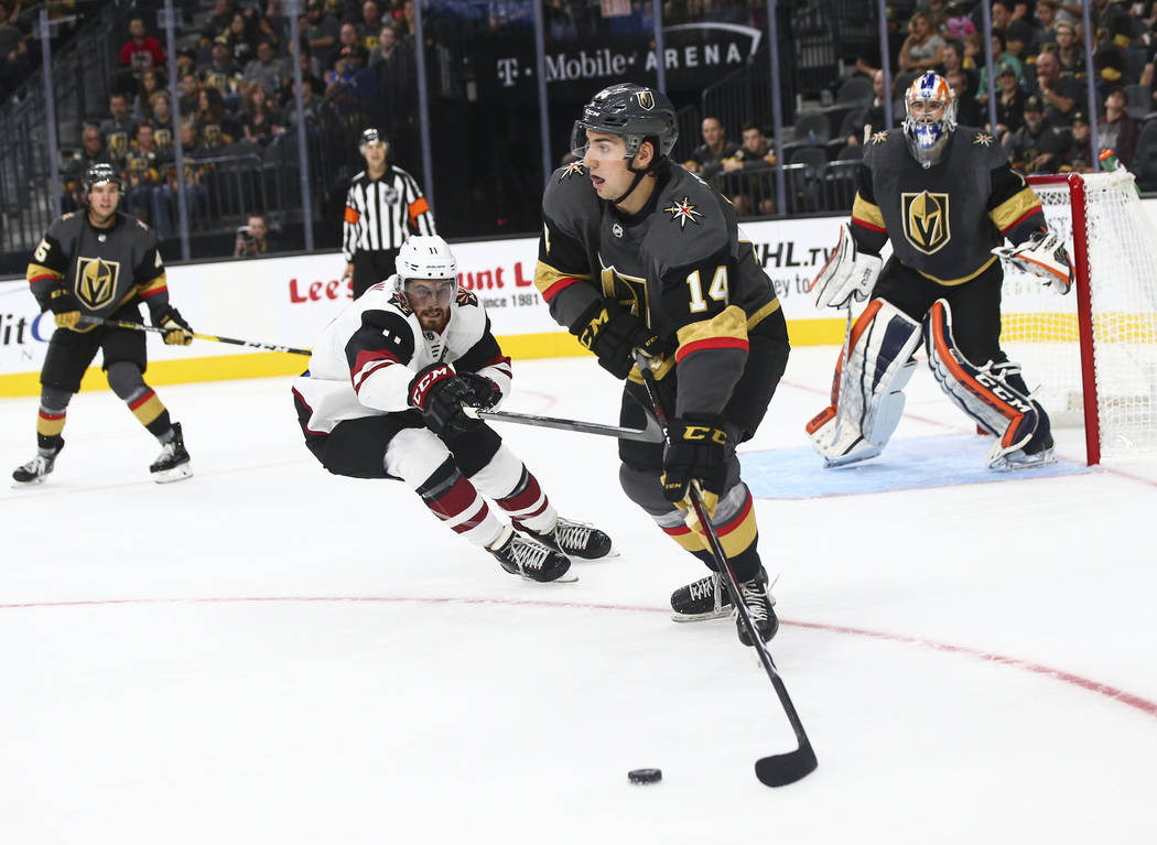 Golden Knights defenseman Nicolas Hague (14) moves the puck against the Arizona Coyotes during the second period of a preseason NHL hockey game at T-Mobile Arena in Las Vegas on Sunday, Sept. 16, ...