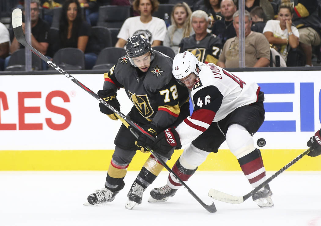 Golden Knights center Gage Quinney (72) battles Arizona Coyotes defenseman Ilya Lyubushkin (46) for the puck during the first period of a preseason NHL hockey game at T-Mobile Arena in Las Vegas o ...