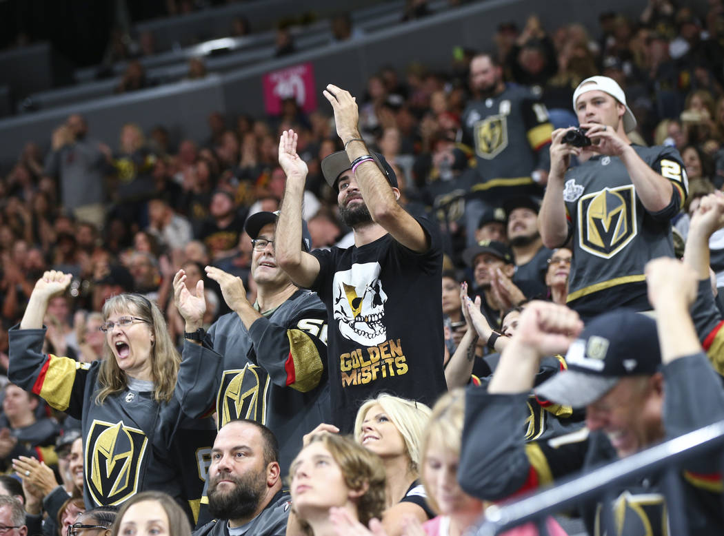 Golden Knights fans celebrate a penalty shot block by Golden Knights goaltender Dylan Ferguson, not pictured during the first period of a preseason NHL hockey game against the Arizona Coyotes at T ...