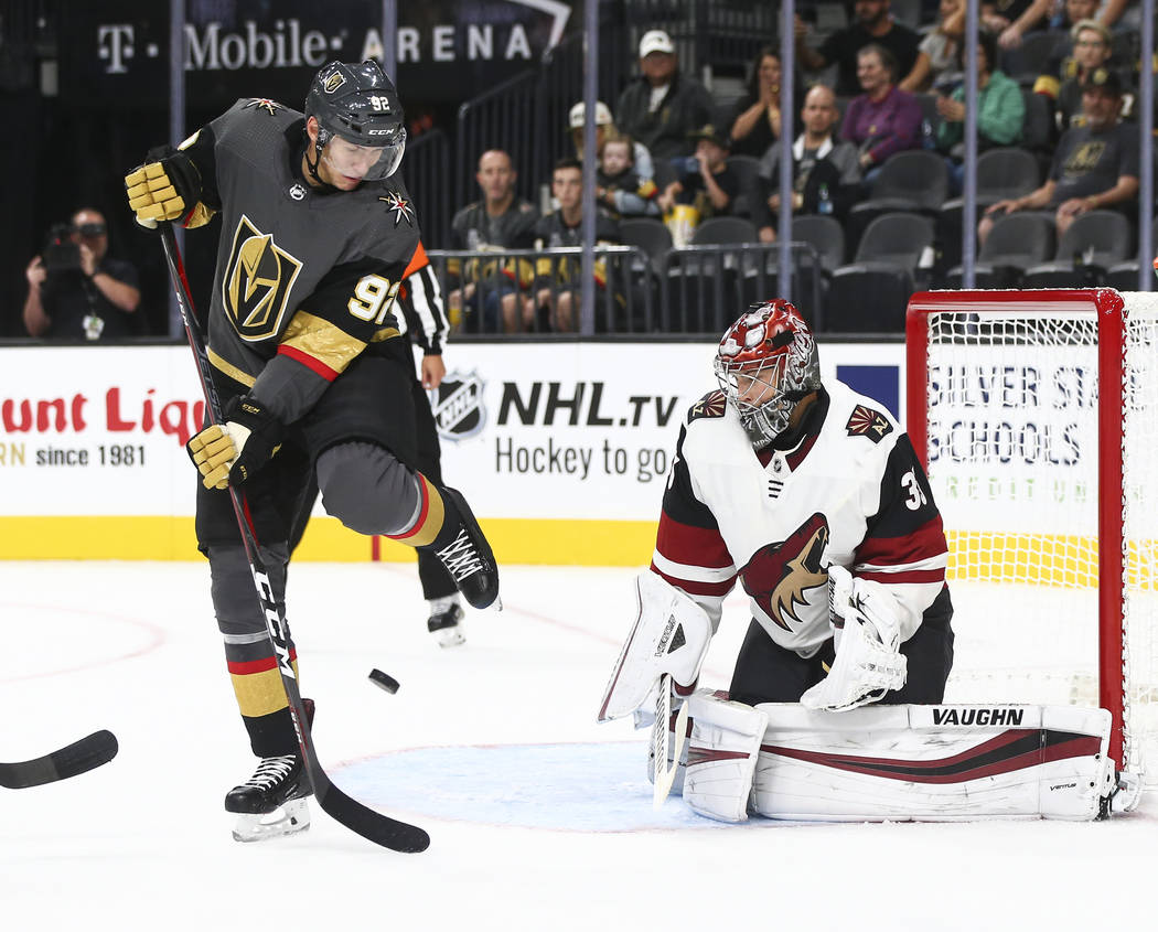 Golden Knights left wing Tomas Nosek (92) looks to get the puck in against Arizona Coyotes goaltender Darcy Kuemper (35) during the first period of a preseason NHL hockey game at T-Mobile Arena in ...