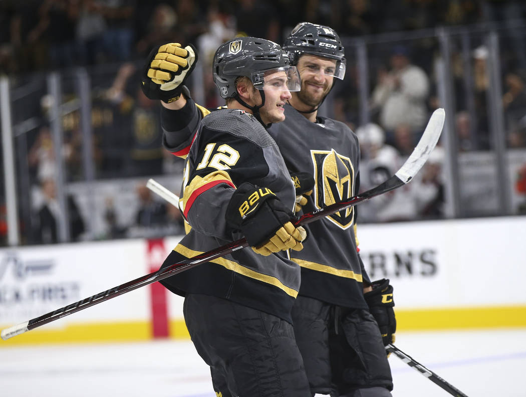 Golden Knights defenseman Erik Brannstrom (12) celebrates his goal with defenseman Colin Miller during the third period of a preseason NHL hockey game against the Arizona Coyotes at T-Mobile Arena ...