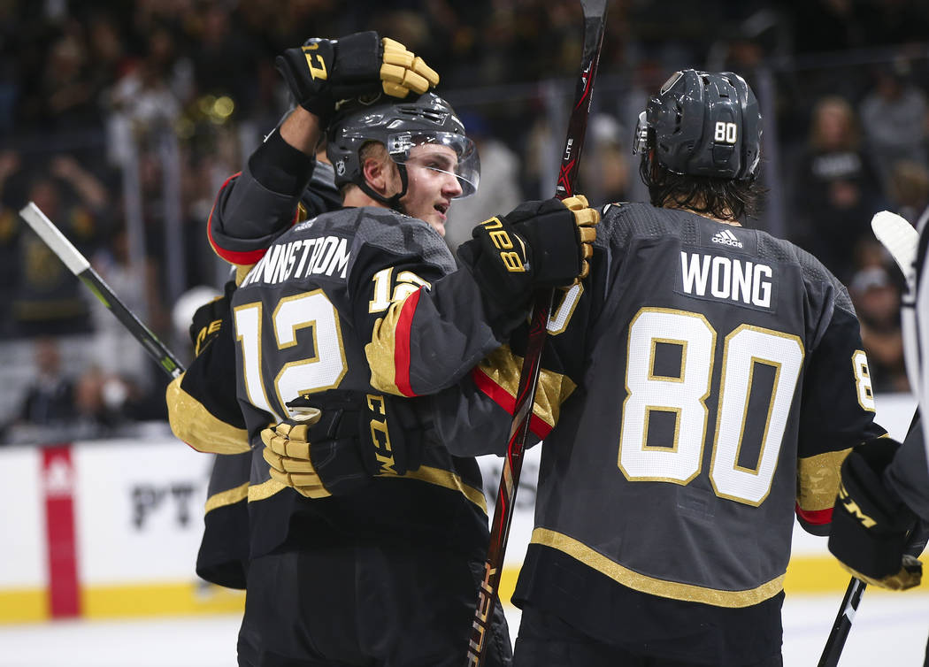 Golden Knights defenseman Erik Brannstrom (12) celebrates his goal with Tyler Wong (80) during the third period of a preseason NHL hockey game against the Arizona Coyotes at T-Mobile Arena in Las ...
