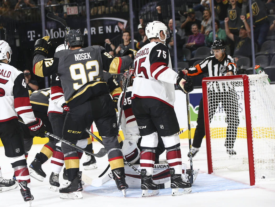 Golden Knights left wing Tomas Nosek (92) celebrates a goal by Golden Knights center William Karlsson (71) against the Arizona Coyotes during the first period of a preseason NHL hockey game at T-M ...