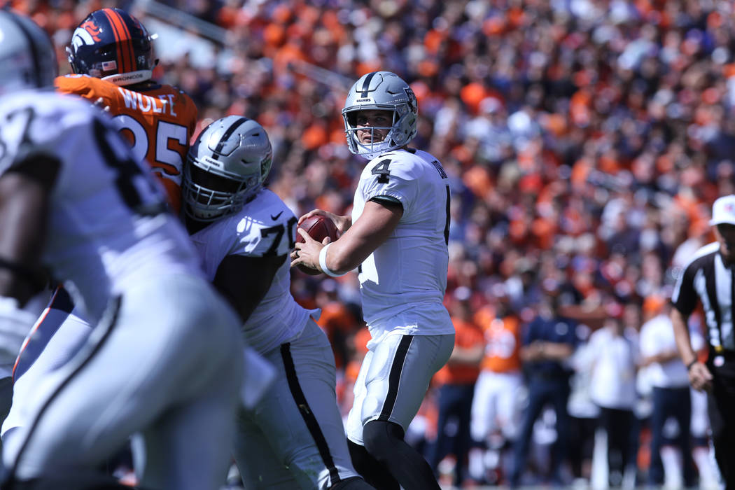 Oakland Raiders quarterback Derek Carr (4) looks to pass the football during the first half of their NFL game against the Denver Broncos in Denver, Colo., Sunday, Sept. 16, 2018. Heidi Fang Las Ve ...