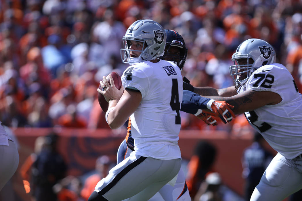 Oakland Raiders offensive tackle Donald Penn (72) tries to hold off Denver Broncos linebacker Von Miller (58) as quarterback Derek Carr (4) looks for an open receiver during the first half of thei ...