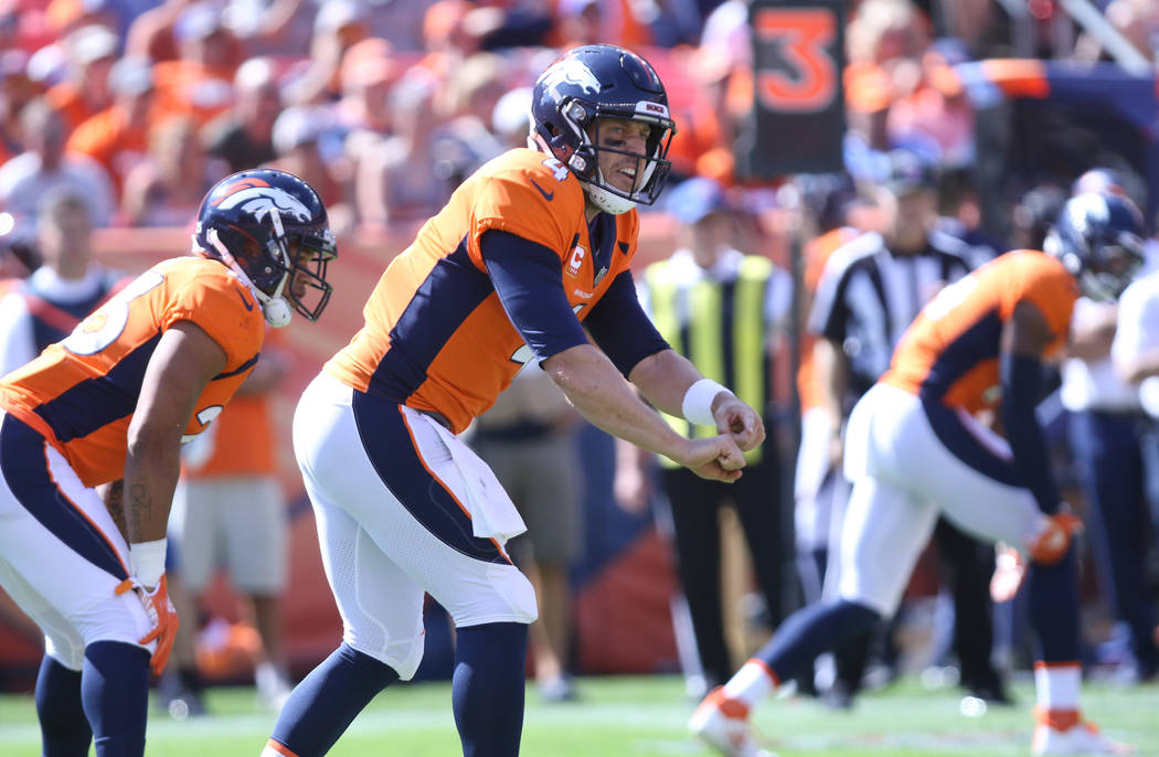 Denver Broncos quarterback Case Keenum (4) calls an audible at the line of scrimmage during the first half of their NFL game against the Oakland Raiders in Denver, Colo., Sunday, Sept. 16, 2018. H ...