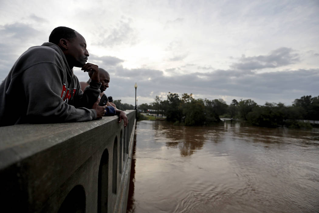 Gerald Generette, left, and Maurice Miller look onto the Cape Fear River as it continues to rise in the aftermath of Florence in Fayetteville, N.C., Monday, Sept. 17, 2018. (David Goldman/AP)