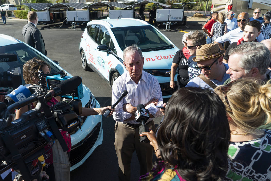 Former New York City mayor Michael Bloomberg speaks with media in front of the Luxor hotel-casino in Las Vegas at "The New American Road Trip," an electric-vehicle tour from California t ...