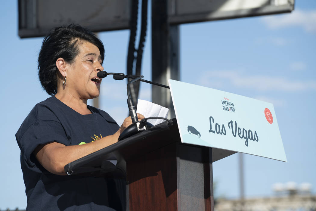 Ivan Meneses, a promoter for Chispa, a conservation organization, speaks in front of the Luxor casino-hotel in Las Vegas at an event for "The New American Road Trip," an electric-vehicle ...