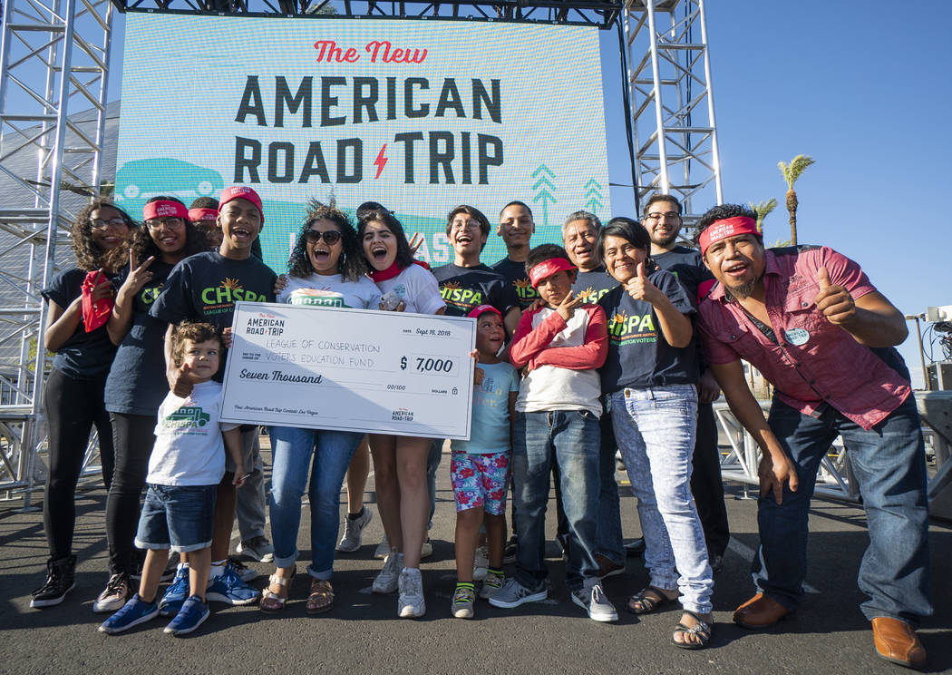 Members of Chispa, a conservation organization focused on replacing diesel school buses with electric school buses, pose for a photograph in front of the Luxor casino-hotel in Las Vegas after rece ...