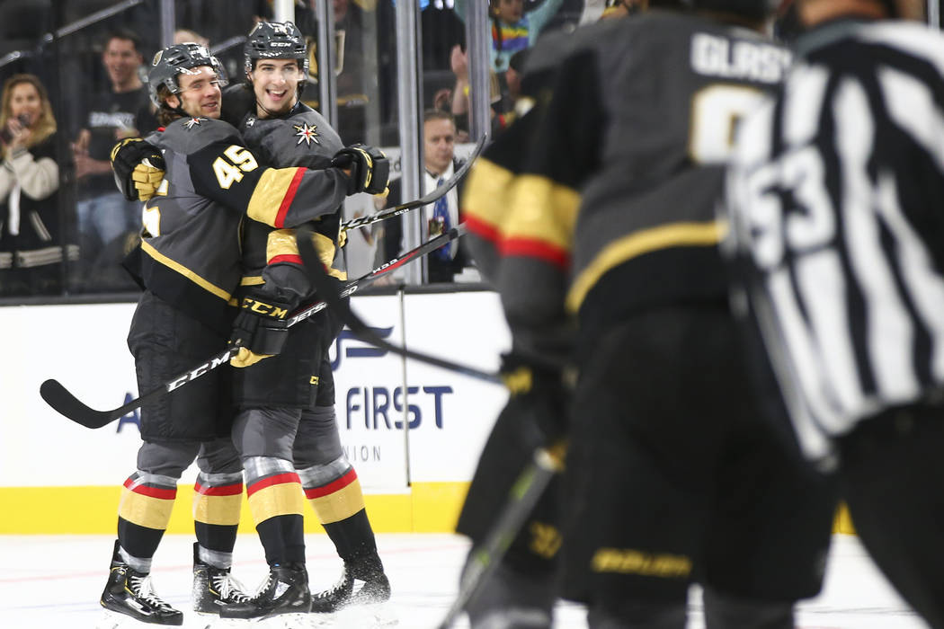 Golden Knights defenseman Jake Bischoff (45) celebrates his goal with Golden Knights defenseman Nicolas Hague (14) during the first period of a preseason NHL hockey game at T-Mobile Arena in Las V ...