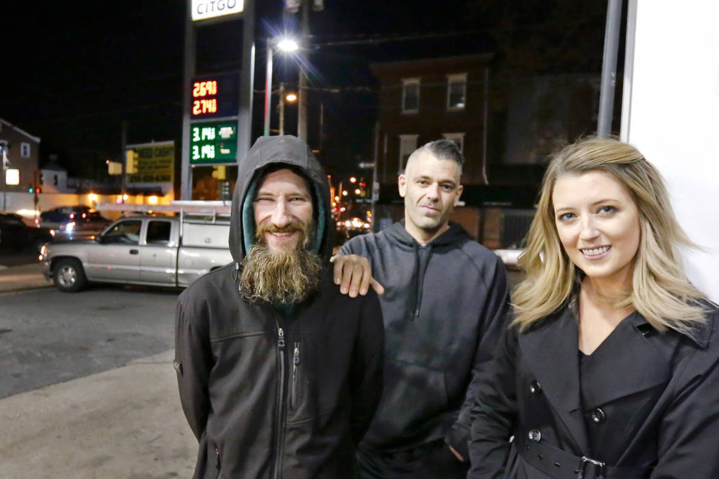 In this Nov. 17, 2017 photo, Johnny Bobbitt Jr., left, Kate McClure, right, and McClure's boyfriend Mark D'Amico pose at a CITGO station in Philadelphia. When McClure ran out of gas, Bobbitt, who ...