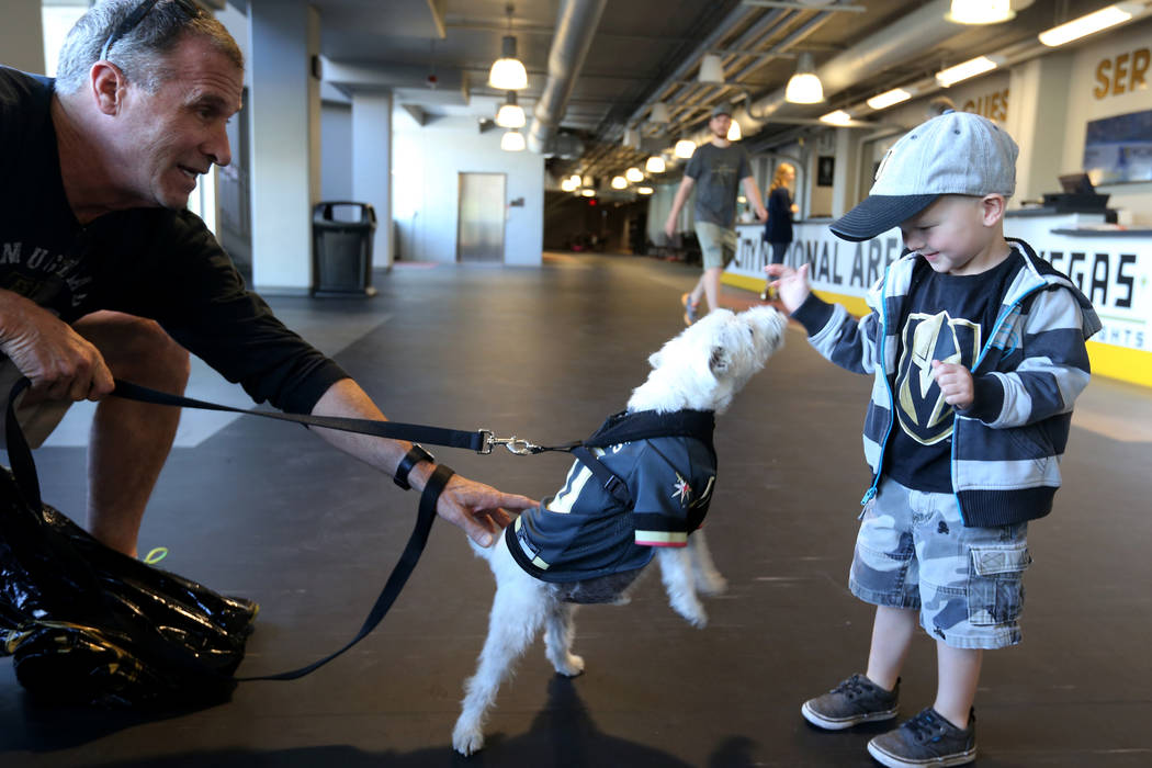 Bark-Andre Furry and his owner Rick Williams say hello to 3-year-old Griffin Schwarz of Las Vegas before Vegas Golden Knights practice at City National Arena in Las Vegas Wednesday, May 9, 2018. K ...