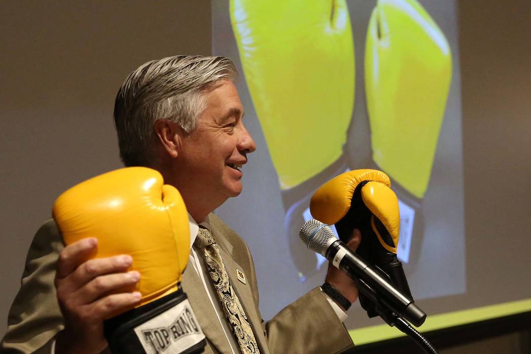 Nevada State College President Bart Patterson holds a pair of boxing gloves as he delivers the State of the College address on Tuesday, Sept. 18, 2018, in Henderson. (Bizuayehu Tesfaye/Las Vegas R ...