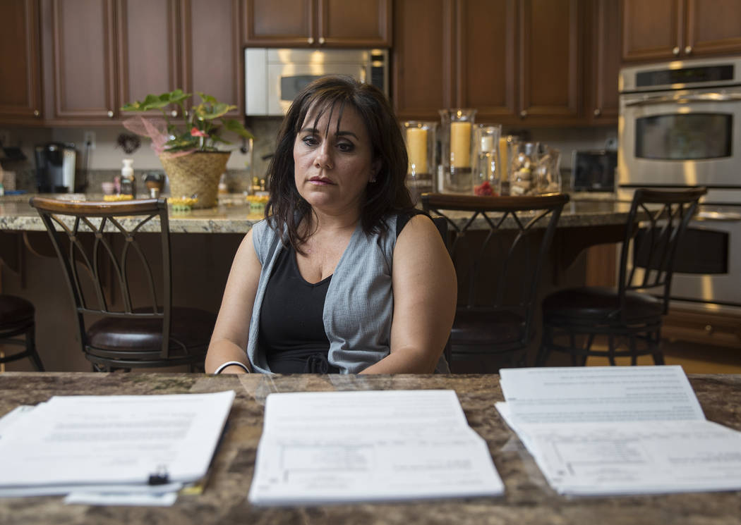 Rose Janise looks at her daughter Rylie Golgart's medical bills she accrued after being shot in the back during the Route 91 shooting on Thursday, Sept. 20, 2018, at Janise's home, in Henderson. B ...
