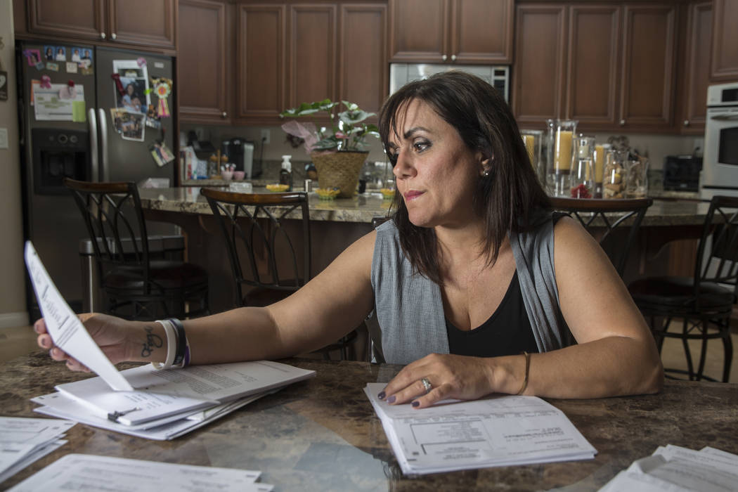 Rose Janise looks through her daughter Rylie Golgart's medical bills she accrued after being shot in the back during the Route 91 shooting on Thursday, Sept. 20, 2018, at Janise's home, in Henders ...