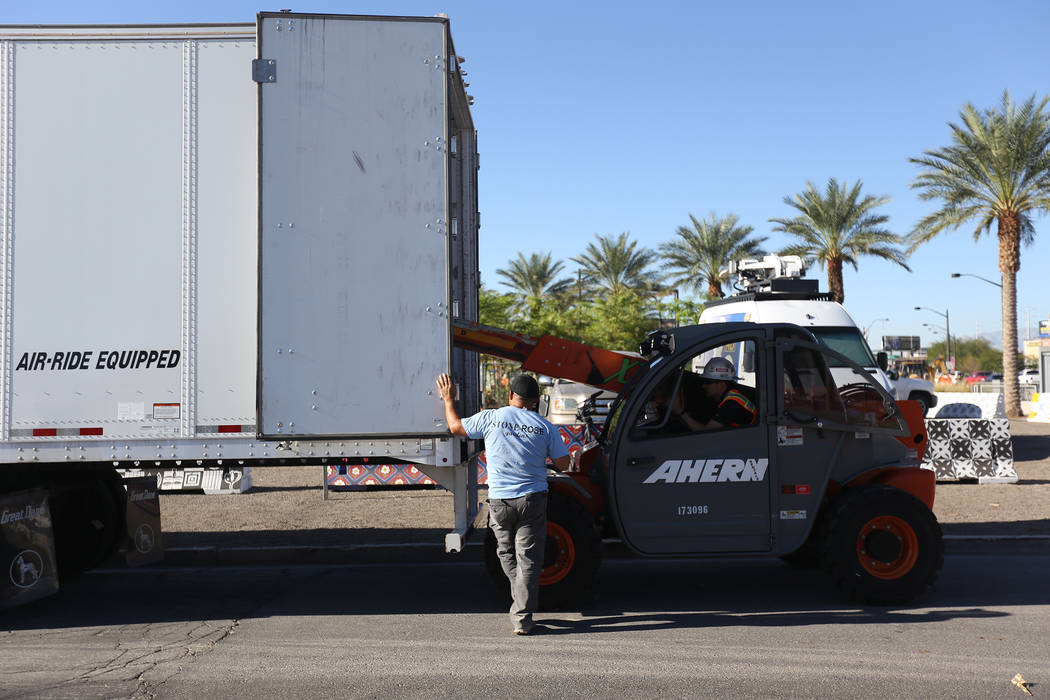 Workers transport the stone sculpture designed by artist Bobby Jacobs to the Healing Garden in Las Vegas, Thursday, Sept. 20, 2018. The back of the wings have the initials of each of the Oct. 1 vi ...