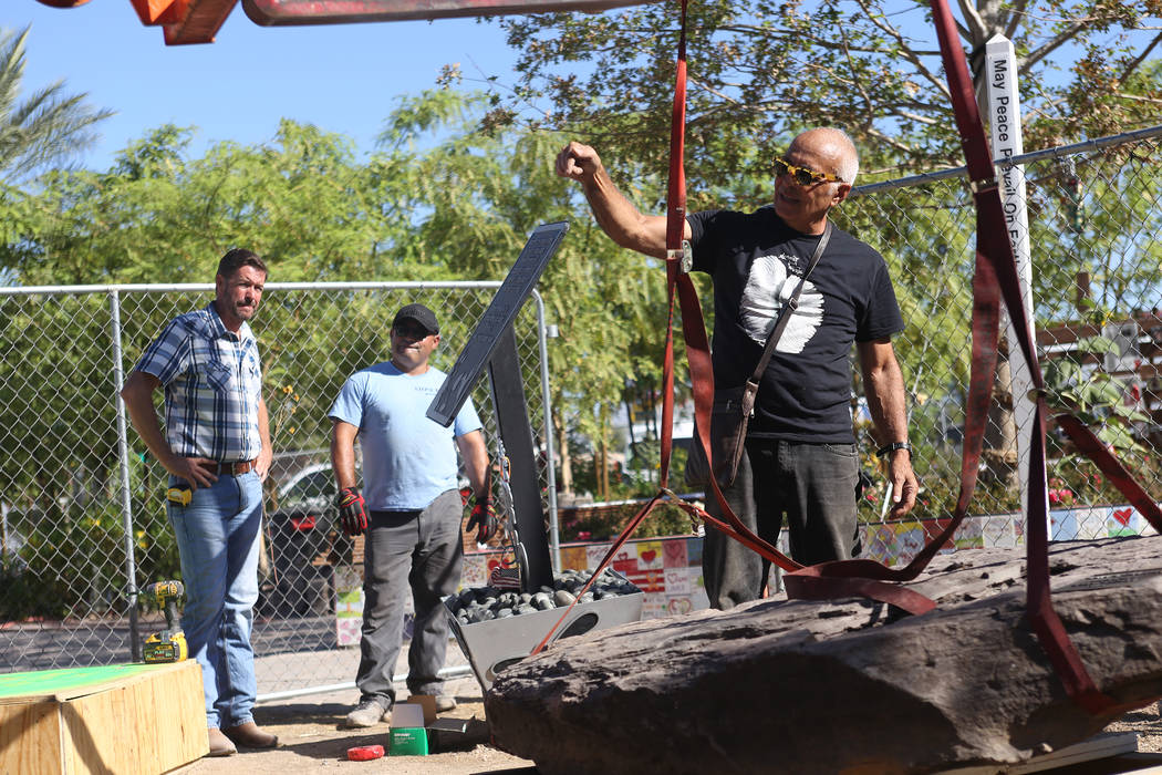 Artist Bobby Jacobs directs workers for the installation of a stone sculpture he created in the Healing Garden in Las Vegas, Thursday, Sept. 20, 2018. The back of the wings of the sculpture have t ...