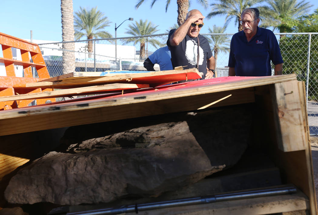 Artist Bobby Jacobs, left, and David Schember, right, oversee the installation of a stone sculpture he created in the Healing Garden in Las Vegas, Thursday, Sept. 20, 2018. The back of the wings o ...