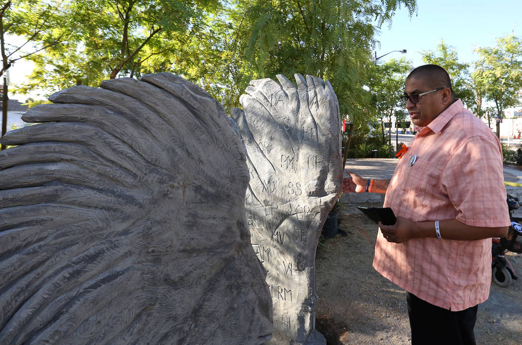Daniel Rosales, a survivor of the Oct. 1 shooting, visits a sculpture of two separate angel wings on Friday, Sept. 21, 2018 at the Las Vegas Healing Garden. The two wings sculpture feature the ini ...