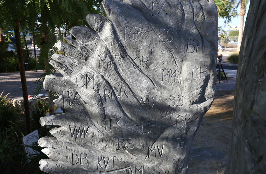 The initials of Oct. 1 shooting victims are carved into a sculpture of two separate angel wings, donated by Bobby Jacobs, an artist from upstate New York, to the Las Vegas Healing Garden on Friday ...