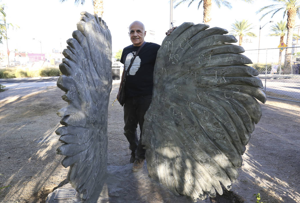 Bobby Jacobs, an artist from upstate New York, poses for photo next to his sculpture of two separate angel wings at the Las Vegas Healing Garden Friday, Sept. 21, 2018. The two wings sculpture fea ...