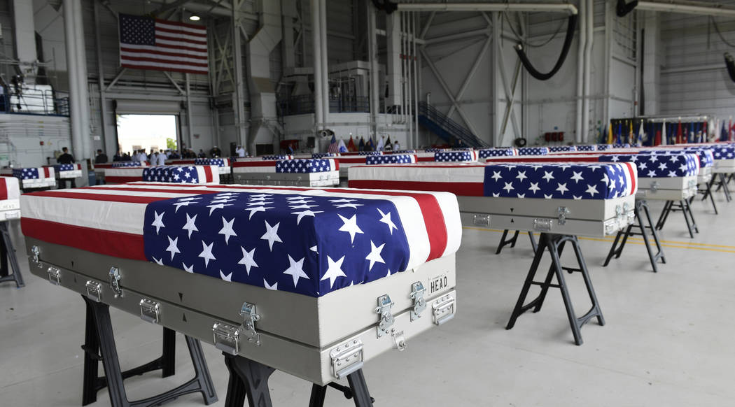 Transfer cases are placed in a hanger at a ceremony marking the arrival of the remains believed to be of American service members who fell in the Korean War at Joint Base Pearl Harbor-Hickam in Ha ...