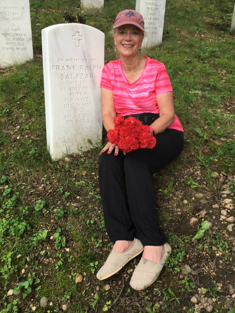 A photo of Diana Sanfilippo, 70, next to her father's tombstone at Arlington National Cemetery. Photo courtesy of Diana Sanfilippo.