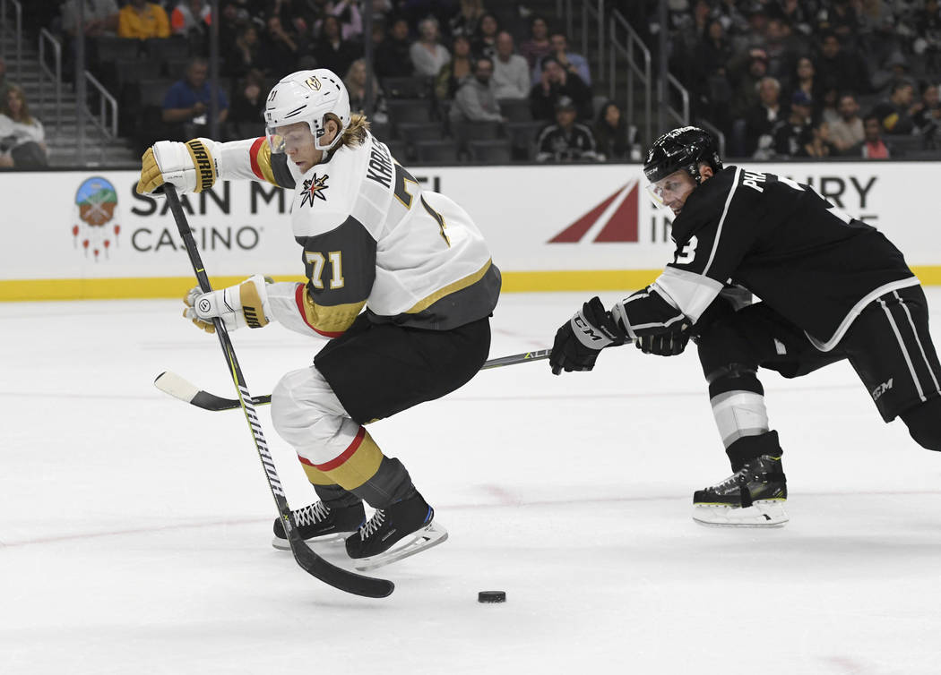 Vegas Golden Knights center William Karlsson (71) passes to a trailing teammate as Los Angeles Kings defenseman Dion Phaneuf defends during the second period of a preseason NHL hockey game Thursda ...