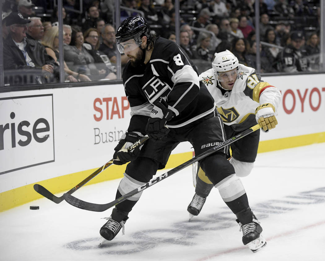 Los Angeles Kings defenseman Drew Doughty (8) clears the puck from Vegas Golden Knights center Jonathan Marchessault (81) during the second period of a preseason NHL hockey game Thursday, Sept. 20 ...