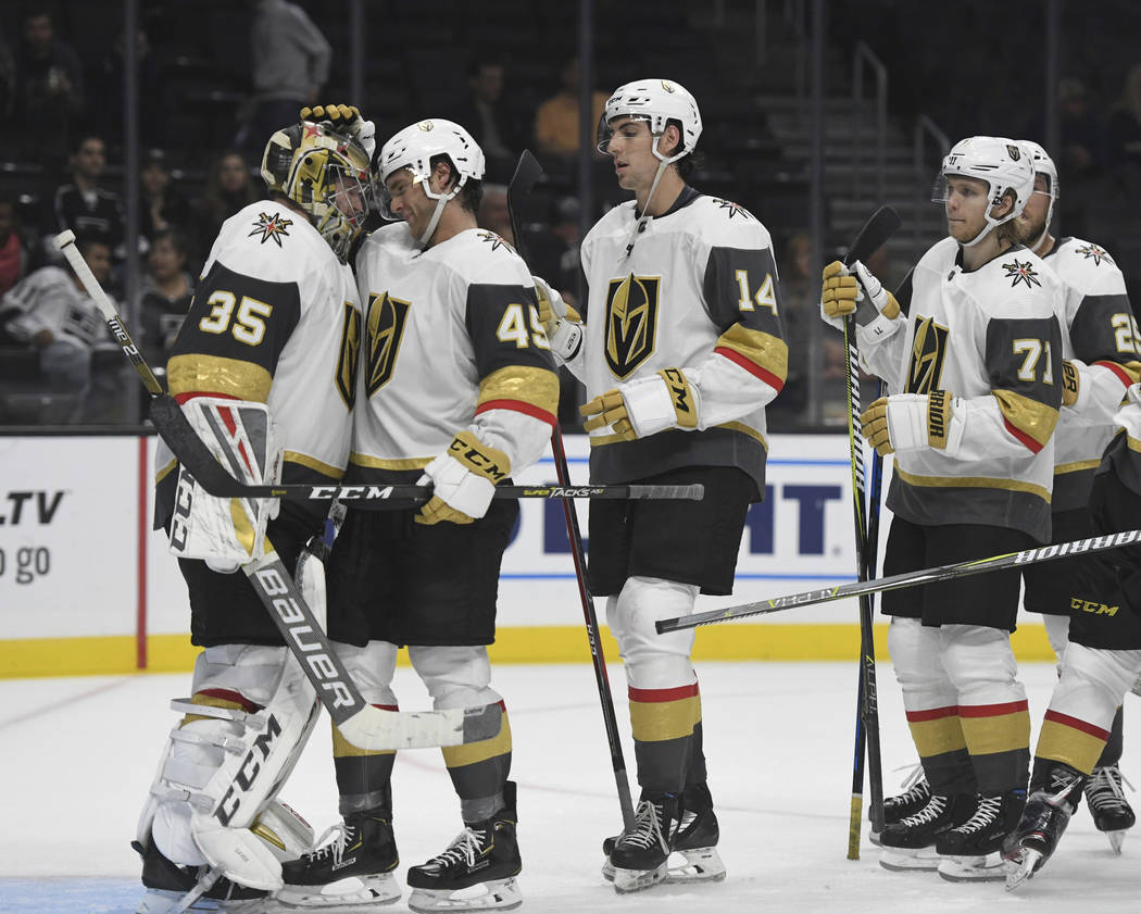 Vegas Golden Knights goalie Oscar Dansk, of Sweden, left, is congratulated by defenseman Jake Bischoff (45) after the Golden Knight defeated the Los Angeles Kings 7-2 in a preseason NHL hockey gam ...